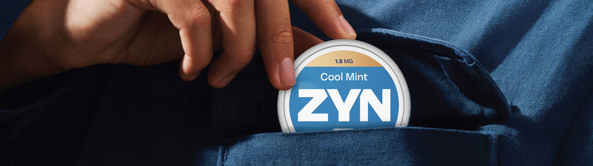 Image of a ZYN Cool Mint nicotine pouch can in a shirt pocket